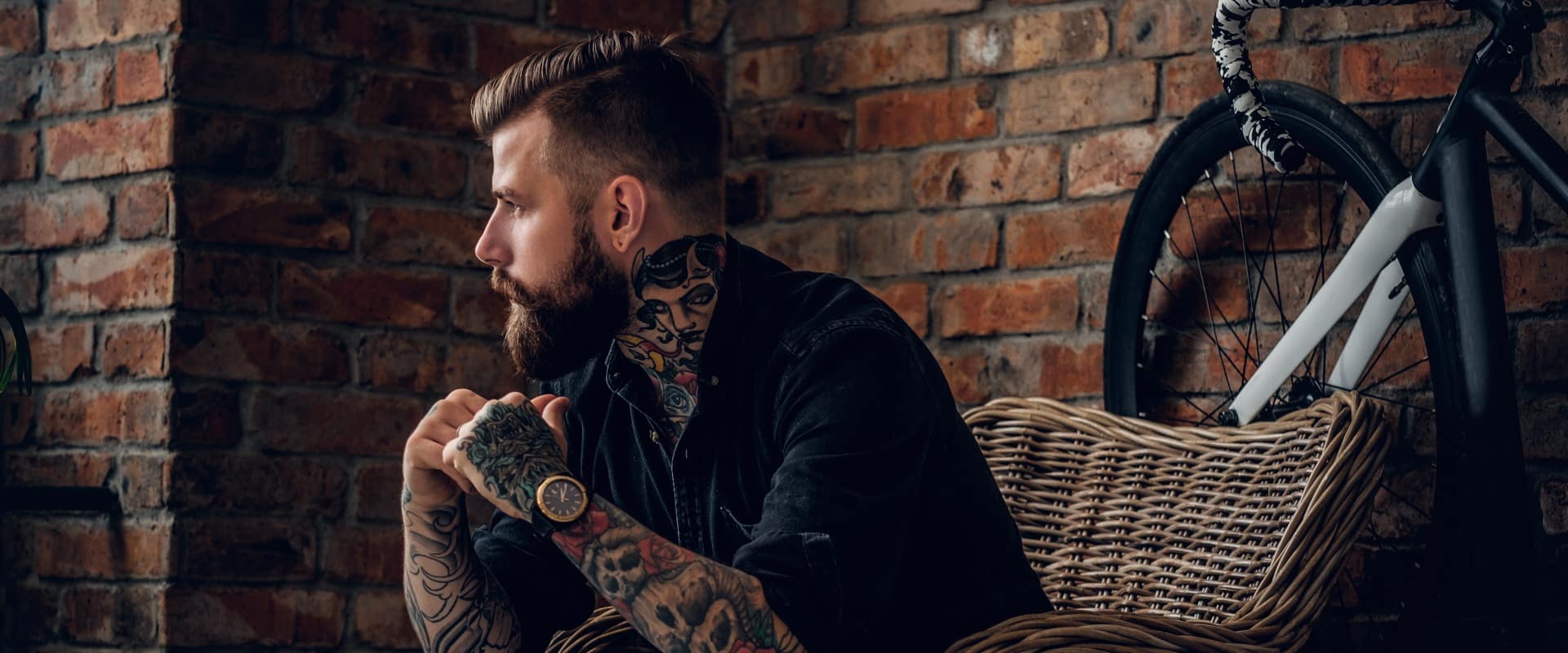 The bearded hipster male relaxing in a chair.